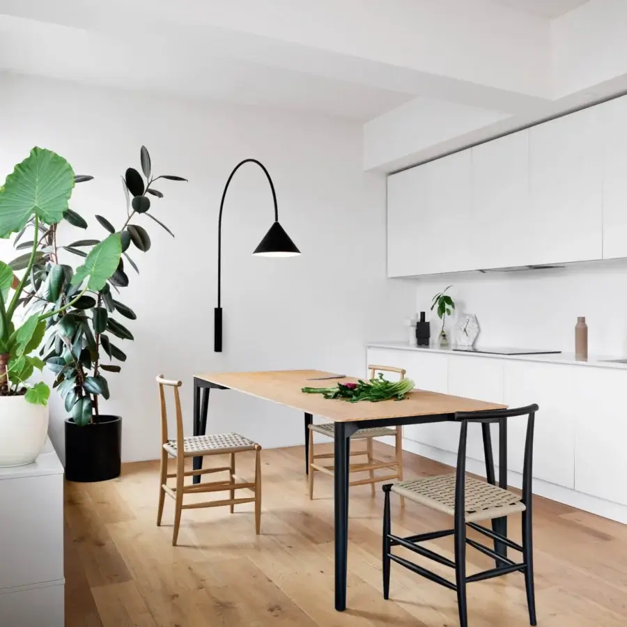 Elegant Miniforms Decapo table crafted in Italy with light-toned wood and dark ‘V’ shaped legs presenting balanced proportions