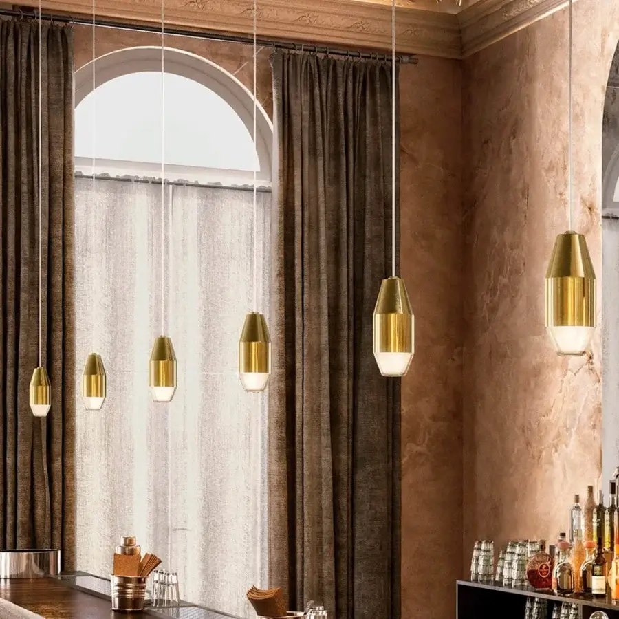 Elegant Kundalini Yuma suspension lamp with spun metal reflector and blown glass diffuser in polished brass