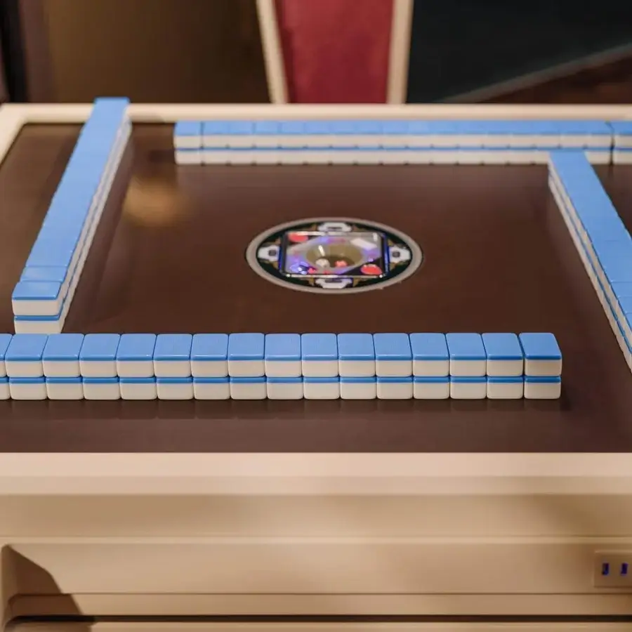 Distinguished Vismara Ming Mahjong table built with a lacquered frame and brown playing surface inlaid with blue and white tiles