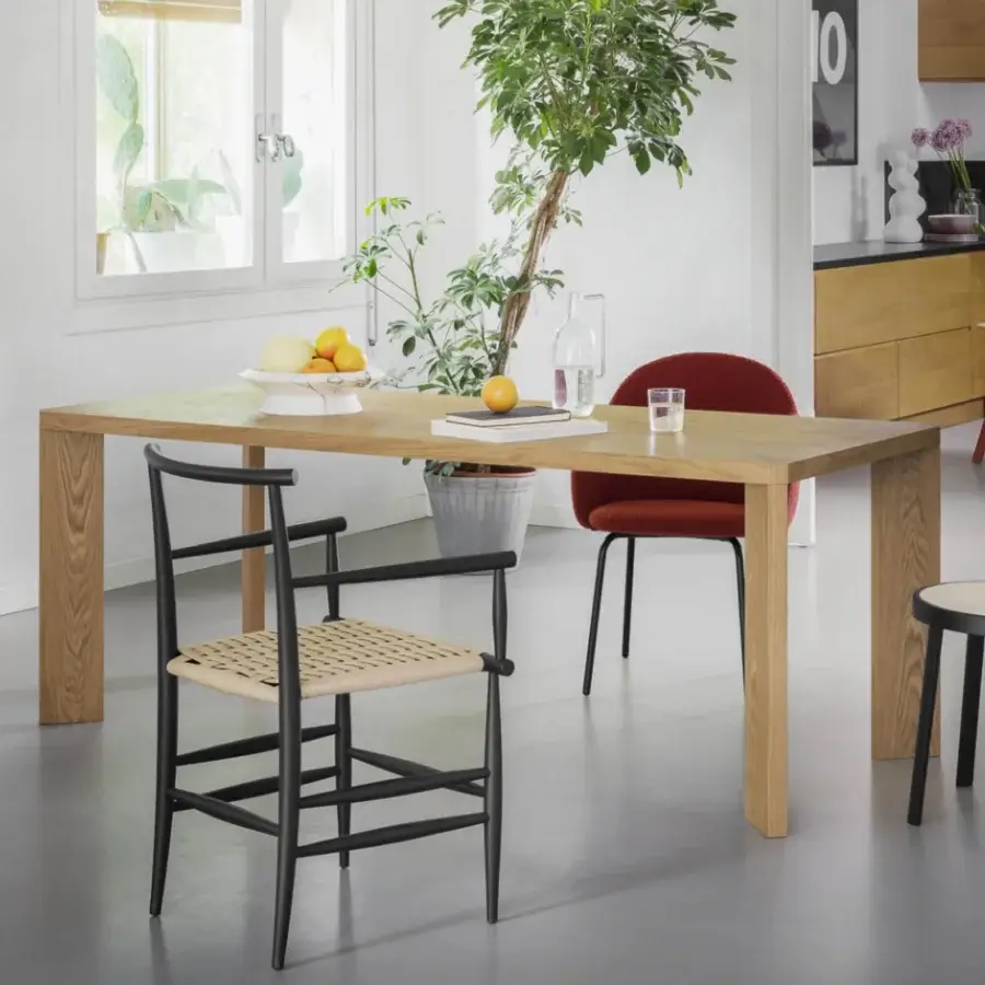 Distinguished Miniforms Manero table crafted in Italy with light brown wood and assertive block legs showcasing natural finish