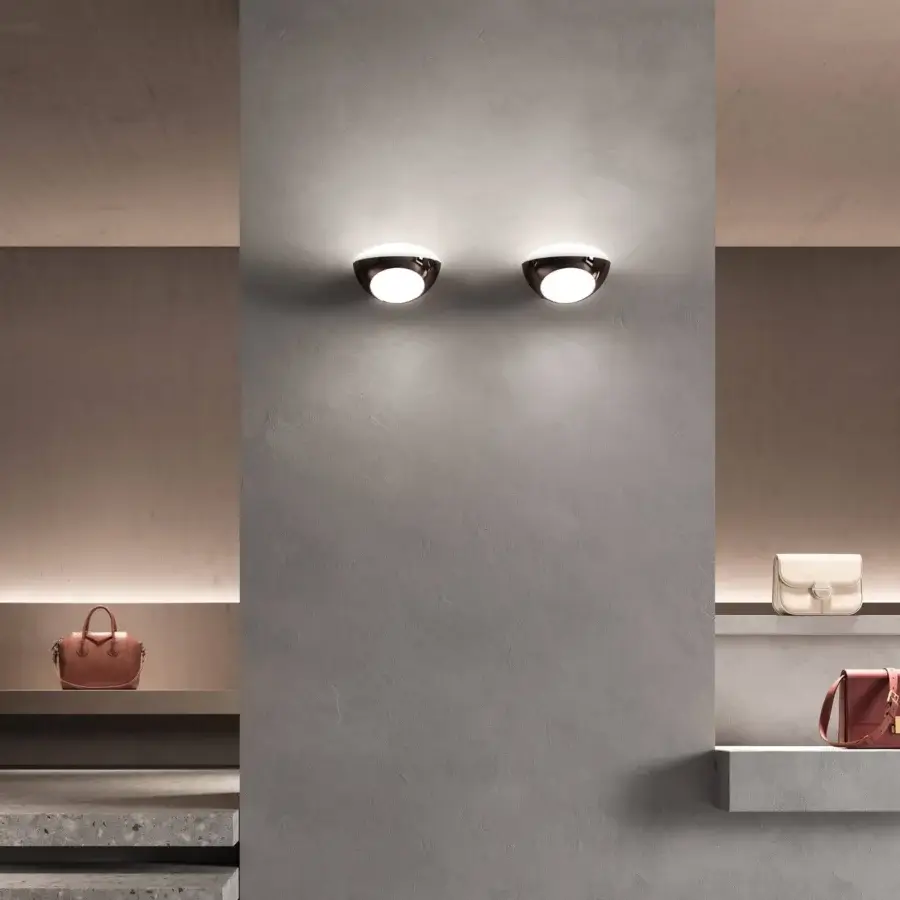 Distinguished Kundalini Tua wall lamp with a black tin frame and frosted glass diffuser embodying smooth curved lines