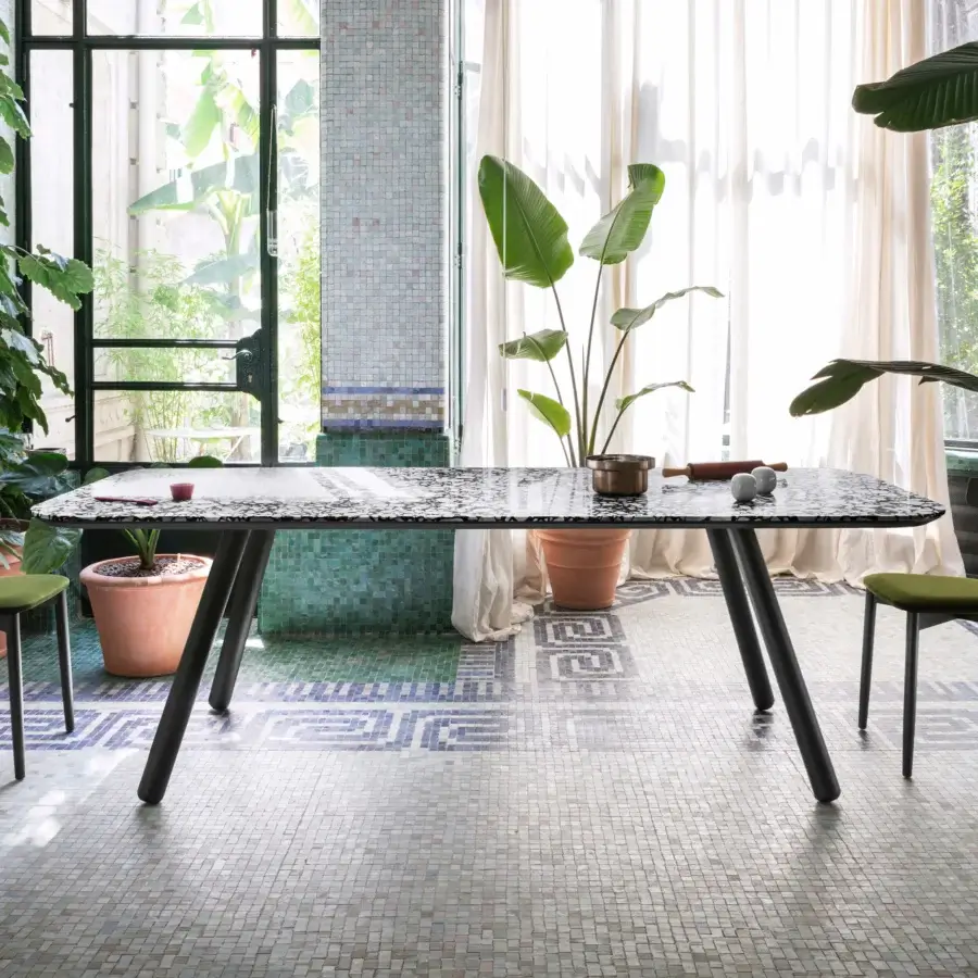 Superior Miniforms Pixie table with speckled terrazzo-like top and dark angled legs in a matte finish