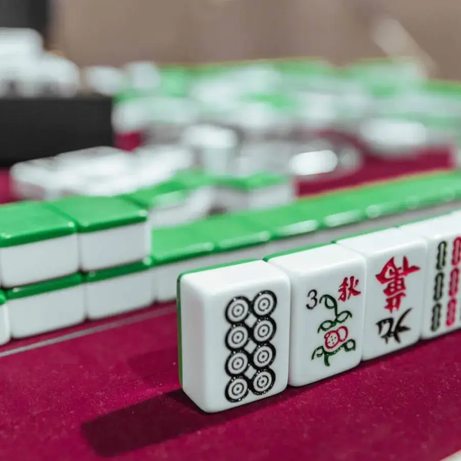 Elegant Vismara Ming Mahjong table in maroon velvet with white tiles and lacquered steel details, a remarkable artisan creation