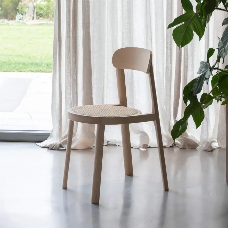 Elegant Miniforms Brulla chair built with light-toned wood and cane webbing showcasing curves with straight lines