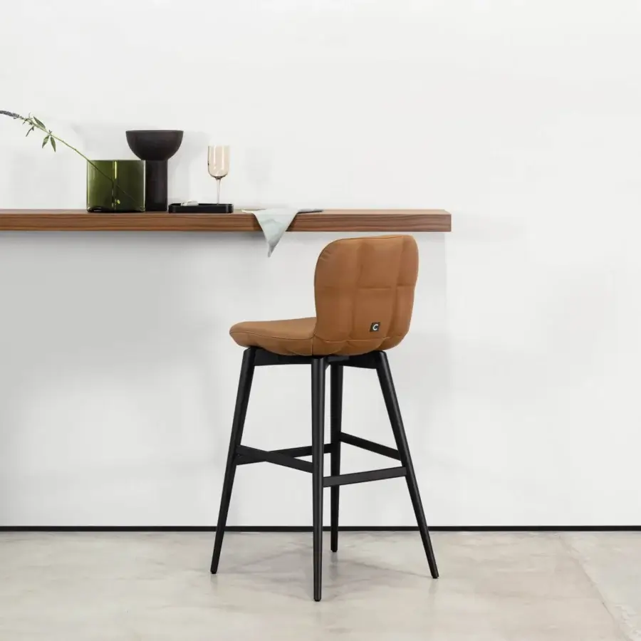 Distinguished Cierre1972 Alain bar stool crafted in rich brown material with quilted backrest and sleek black metal legs