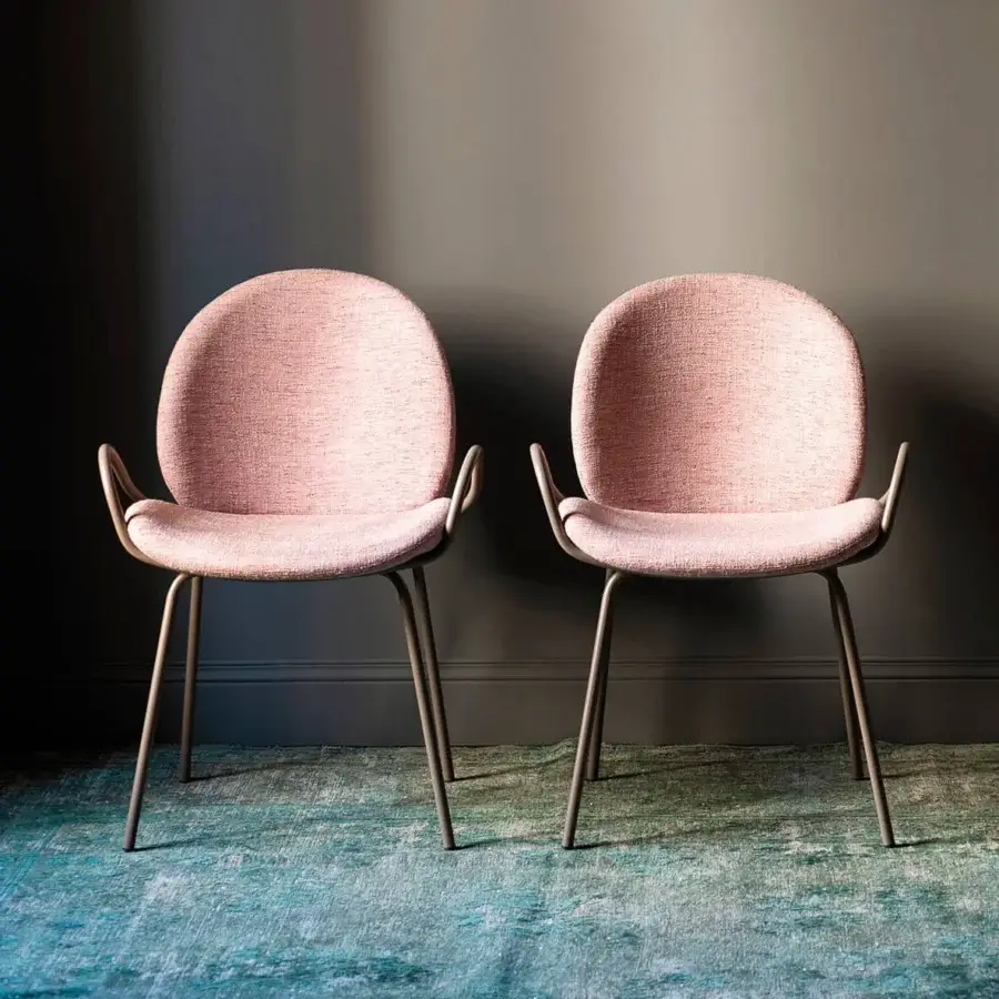 Captivating Bross Baltea armchair with rounded form fully upholstered in pink woven fabric and greyish-brown metal structure
