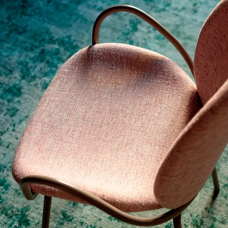 Captivating Bross Baltea armchair with a metal frame fully upholstered in muted pink textured fabric