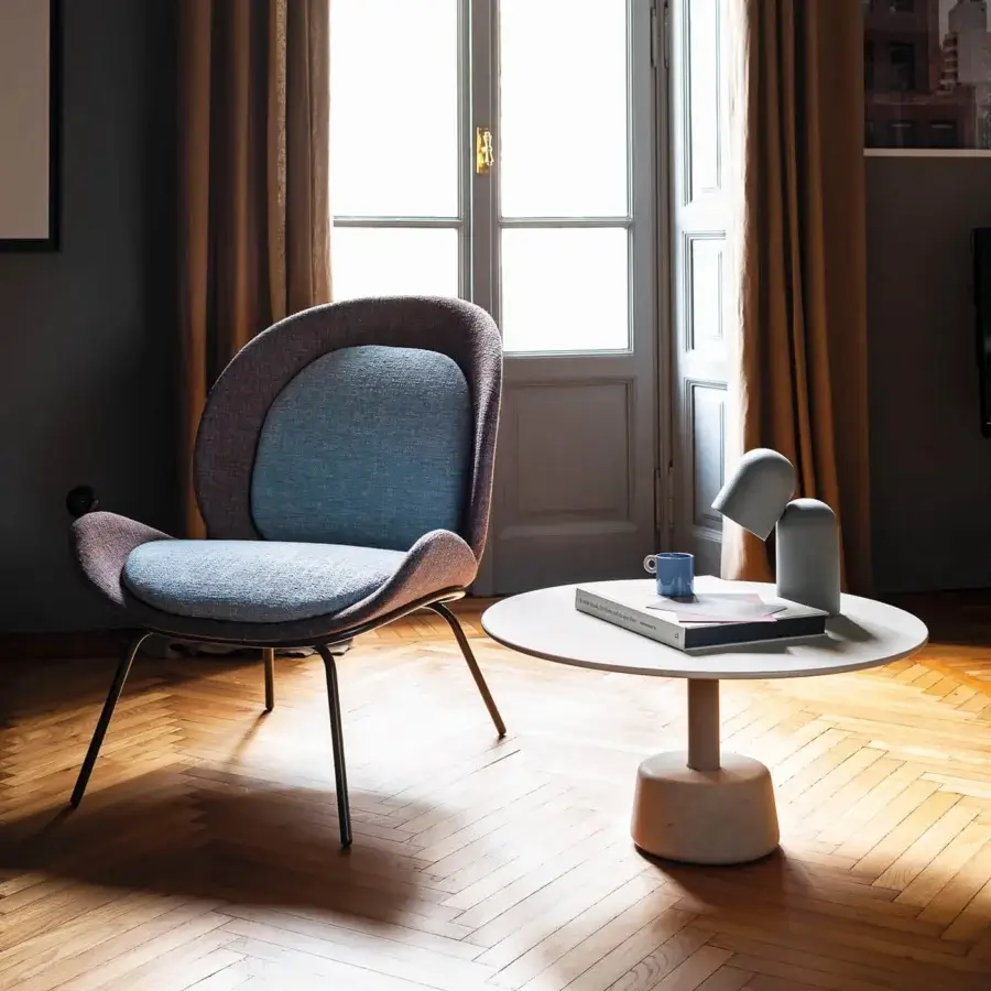 Sophisticated Bross Baltea lounge chair with dual-tone fabric upholstery and matte black metal legs crafted in Italy