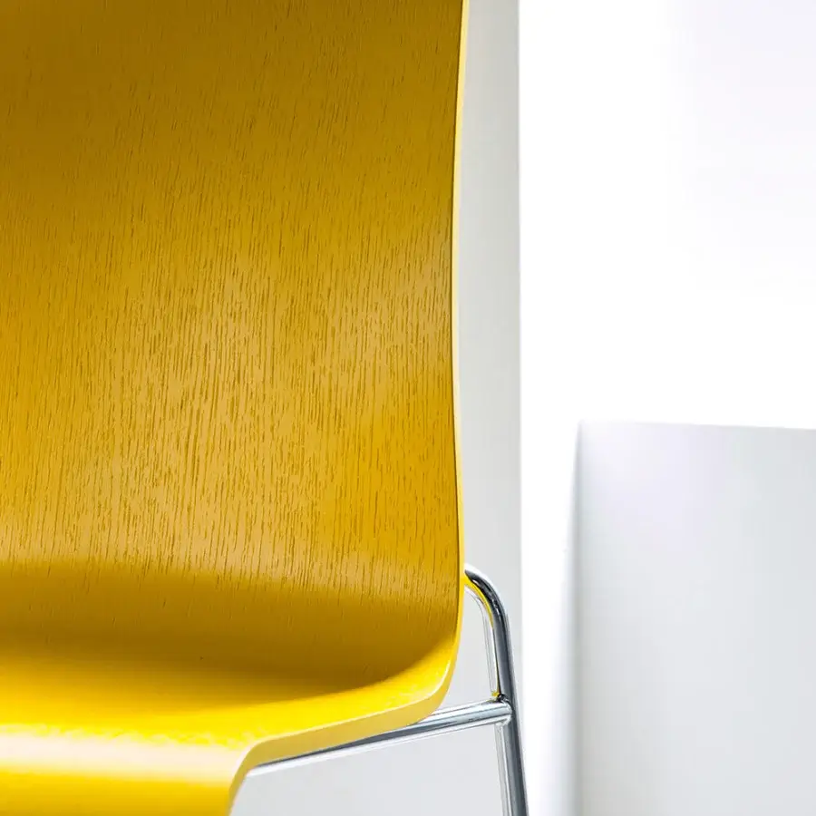 Exceptional Bross Bee chair with wood seat and back built with a glossy yellow finish and thin silver metal frame