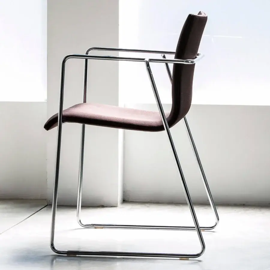 Elegant Bross Bee armchair with dark brown fabric upholstery and polished metal frame built in a continuous loop
