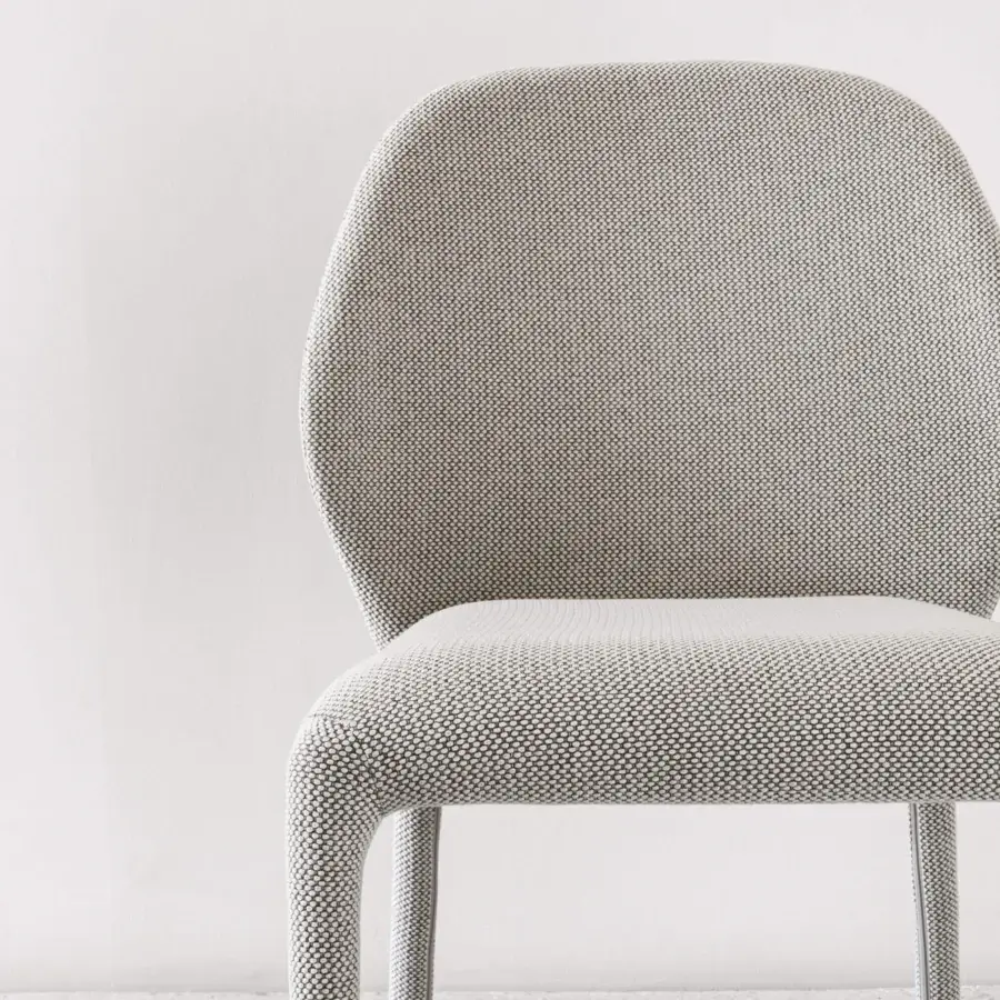 Distinguished Miniforms Dumbo chair with light gray woven textile upholstery and distinctive curved backrest design