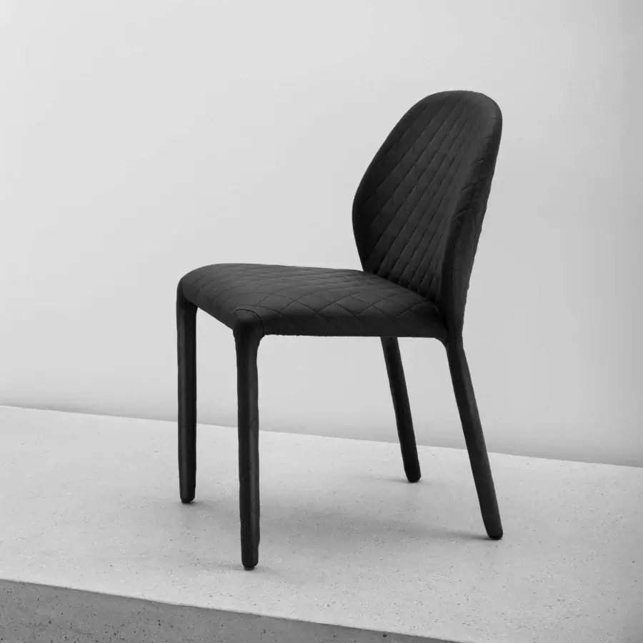 Exceptional Miniforms Dumbo chair with black matte material and quilted detailing offering inviting comfort