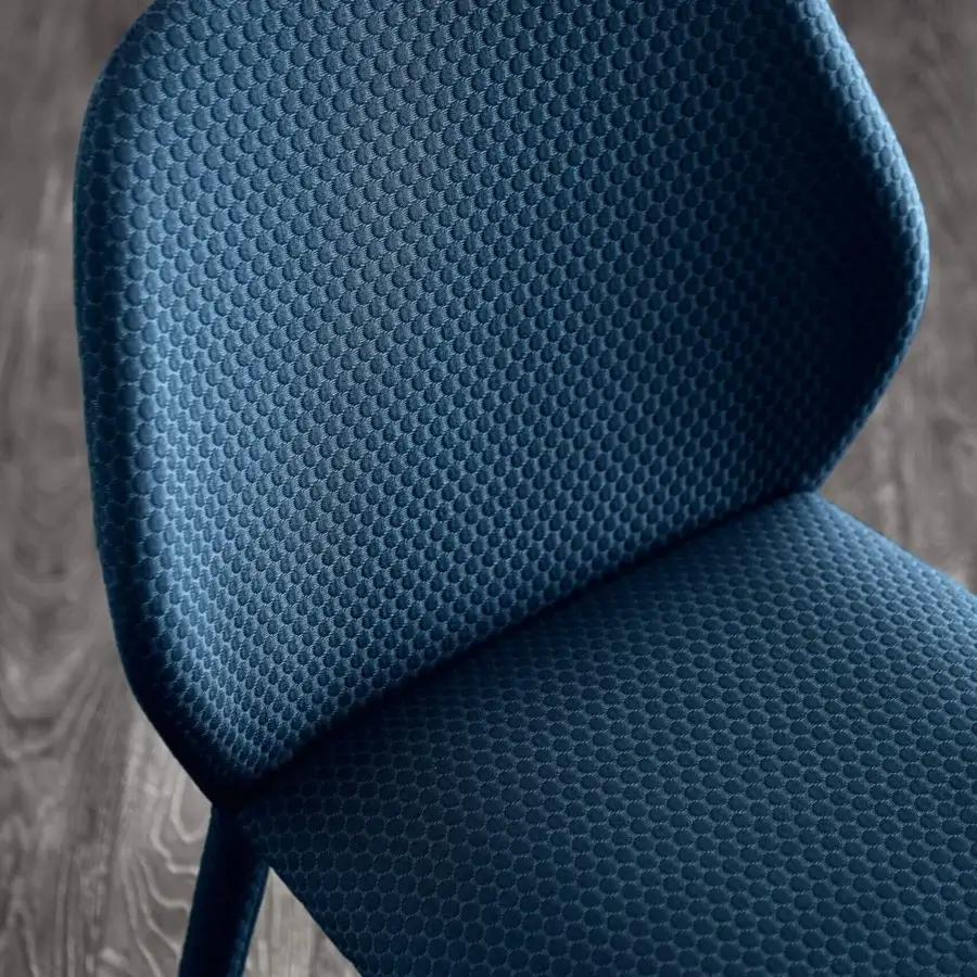Superior Miniforms Dumbo chair with dark blue textile upholstery and textured circular patterns offering balanced proportions
