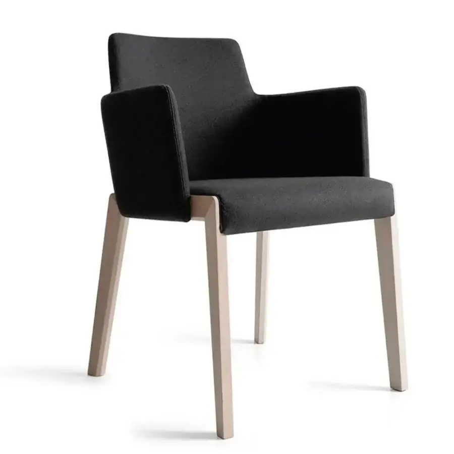 Distinguished Bross Bridget armchair with light-toned wood legs and dark textile upholstery exhibiting a minimalist aesthetic