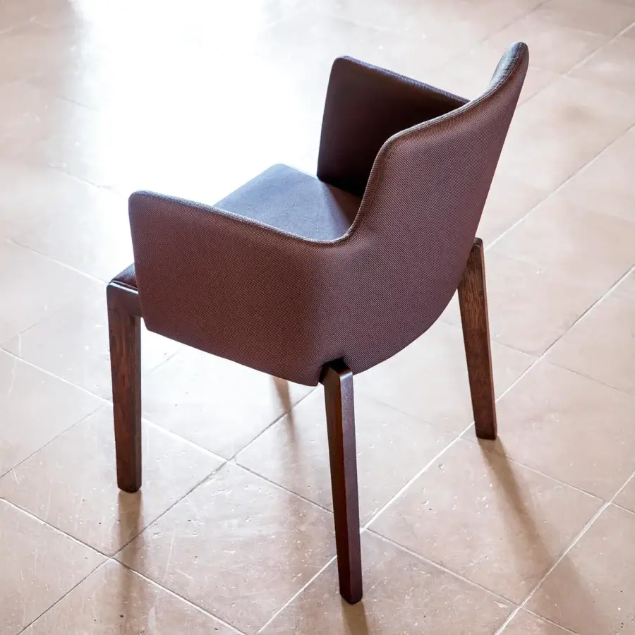 Handcrafted Bross Bridget armchair with muted brown fabric upholstery and high-end wood legs embodying a sleek silhouette