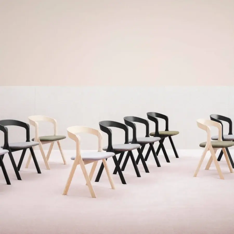 Architectural Miniforms Diverge chair with light-toned wood and olive green fabric, embodying a compass design inspiration