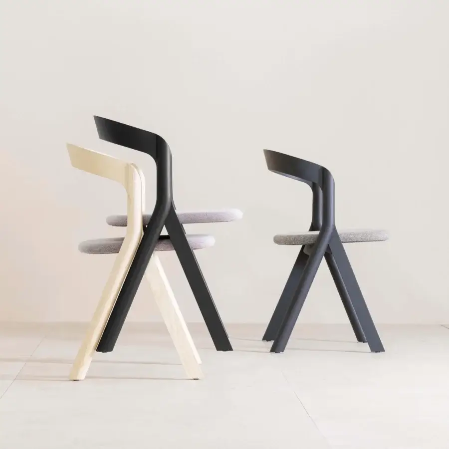 Elegant Miniforms Diverge chair with light-toned wood frame and light gray textile, exhibiting a smooth finish
