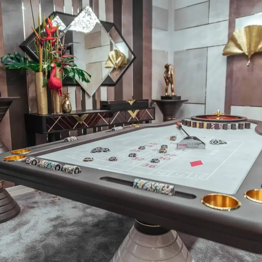 Superior Vismara Montecarlo roulette table with light gray lacquered glass and gold-toned steel accents in a contemporary style
