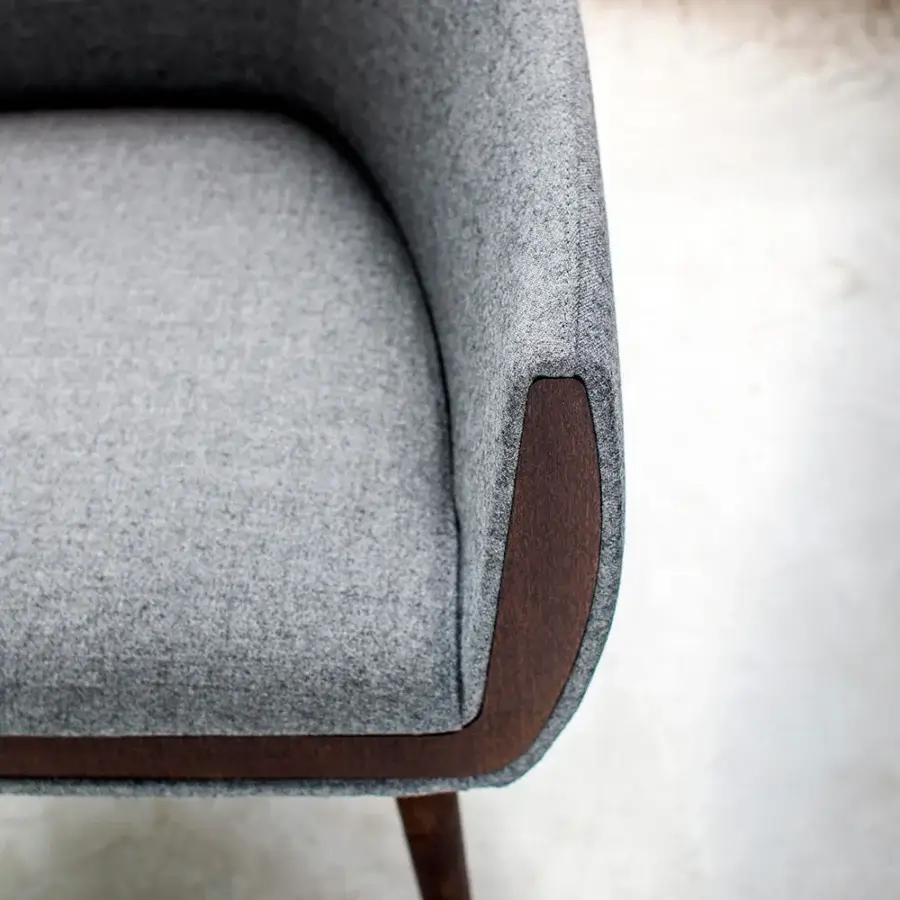 Superior Bross Ginevra armchair in light grey textured fabric with dark brown wood trim and sculpted legs