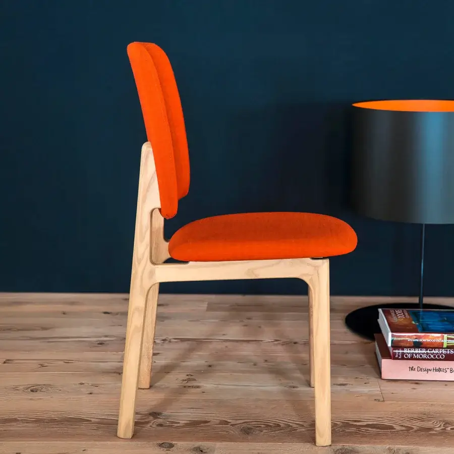 Exceptional Bross Gisa chair crafted in Italy with vibrant orange fabric and light-toned wood structure