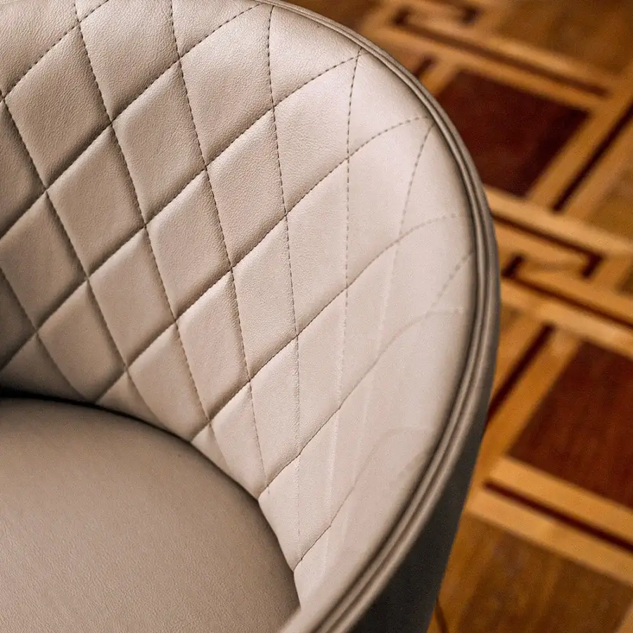 Elegant Bross Hug armchair with quilted light beige fabric and dark-colored wood finish crafted in Italy