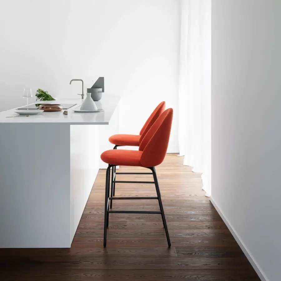 Distinguished Miniforms Iola stool with expanded polyurethane shell upholstered in textured orange textile and dark matte metal legs