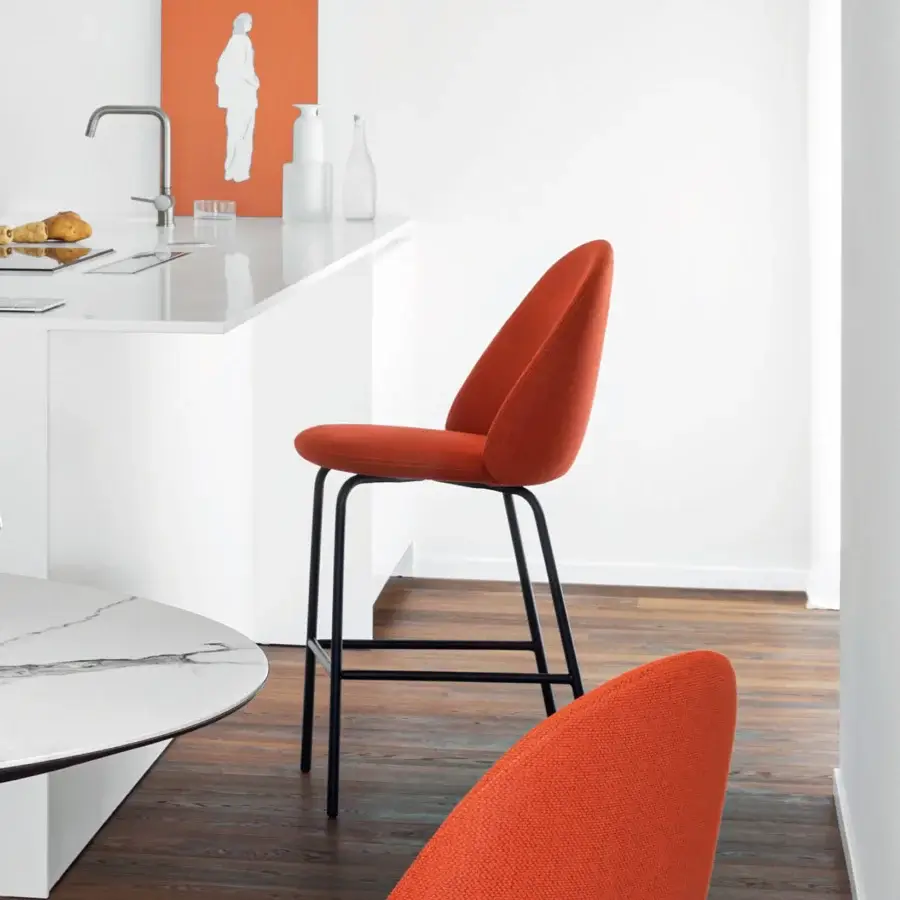 Exceptional Miniforms Iola stool crafted with expanded polyurethane shell upholstered in textured burnt orange textile and matte black metal frame