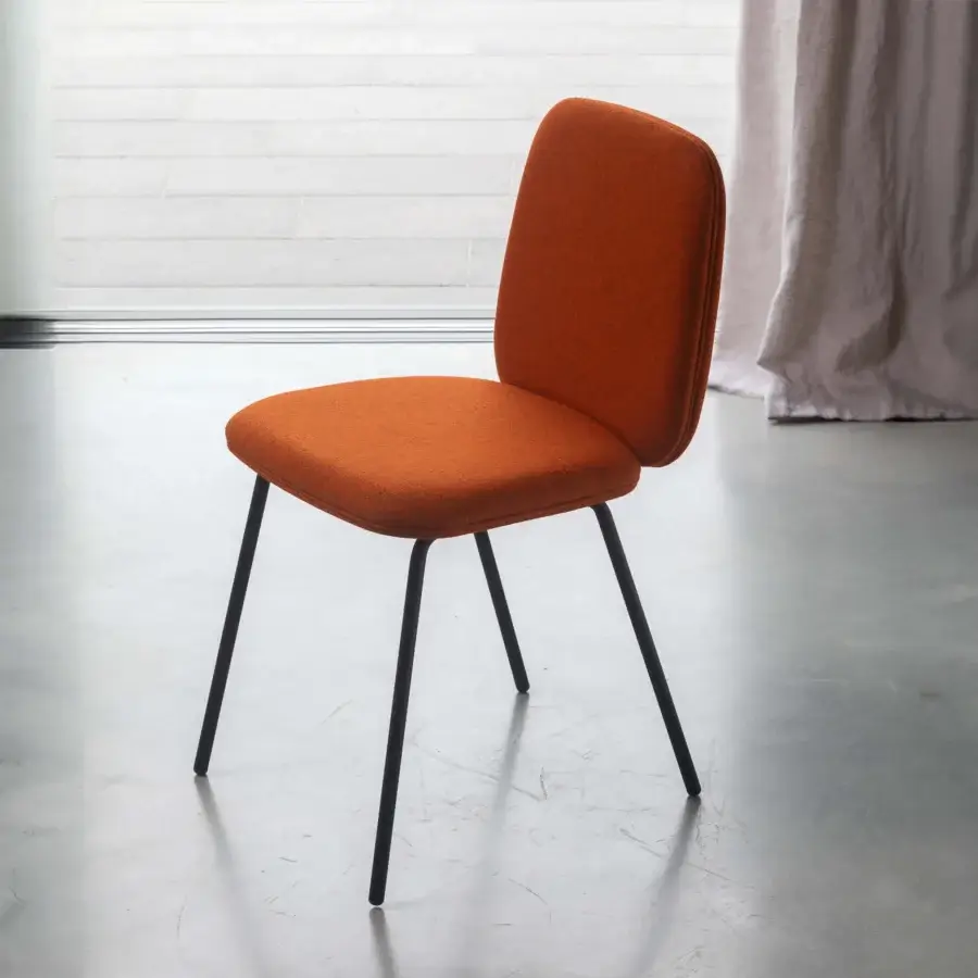 Distinguished Miniforms Leda chair with soft silhouette in textured orange textile and dark matte metal legs