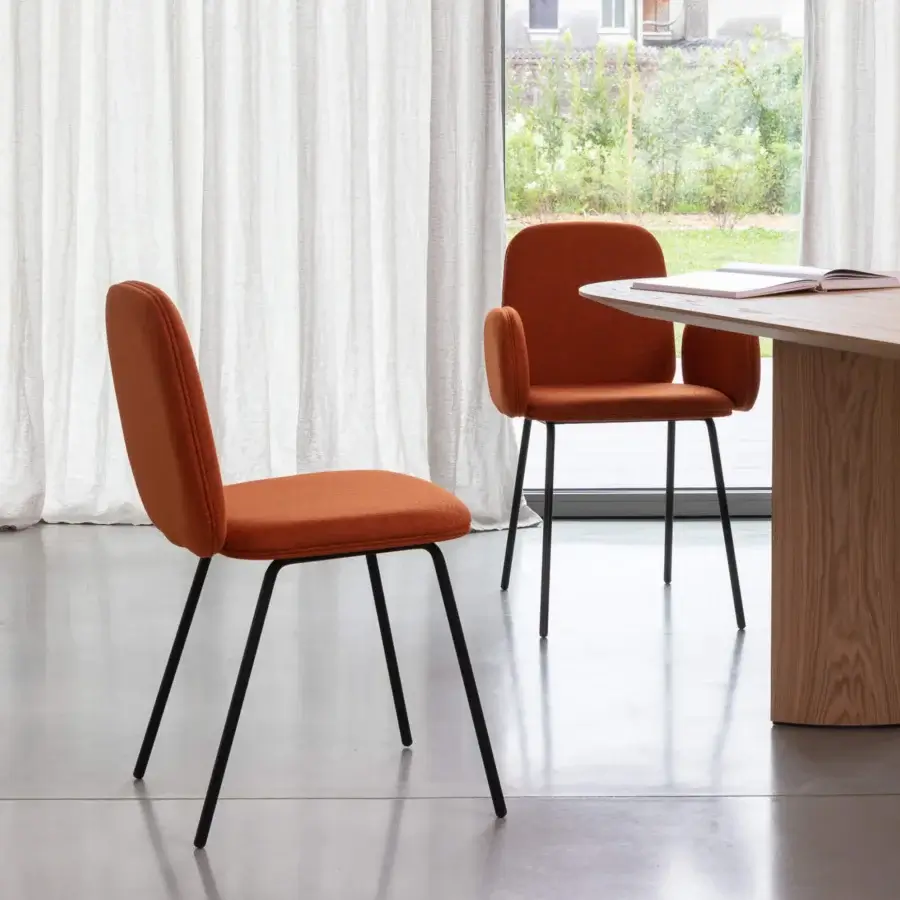 Distinguished Miniforms Leda chair with soft silhouette in warm rust woven textile and matte black metal frame