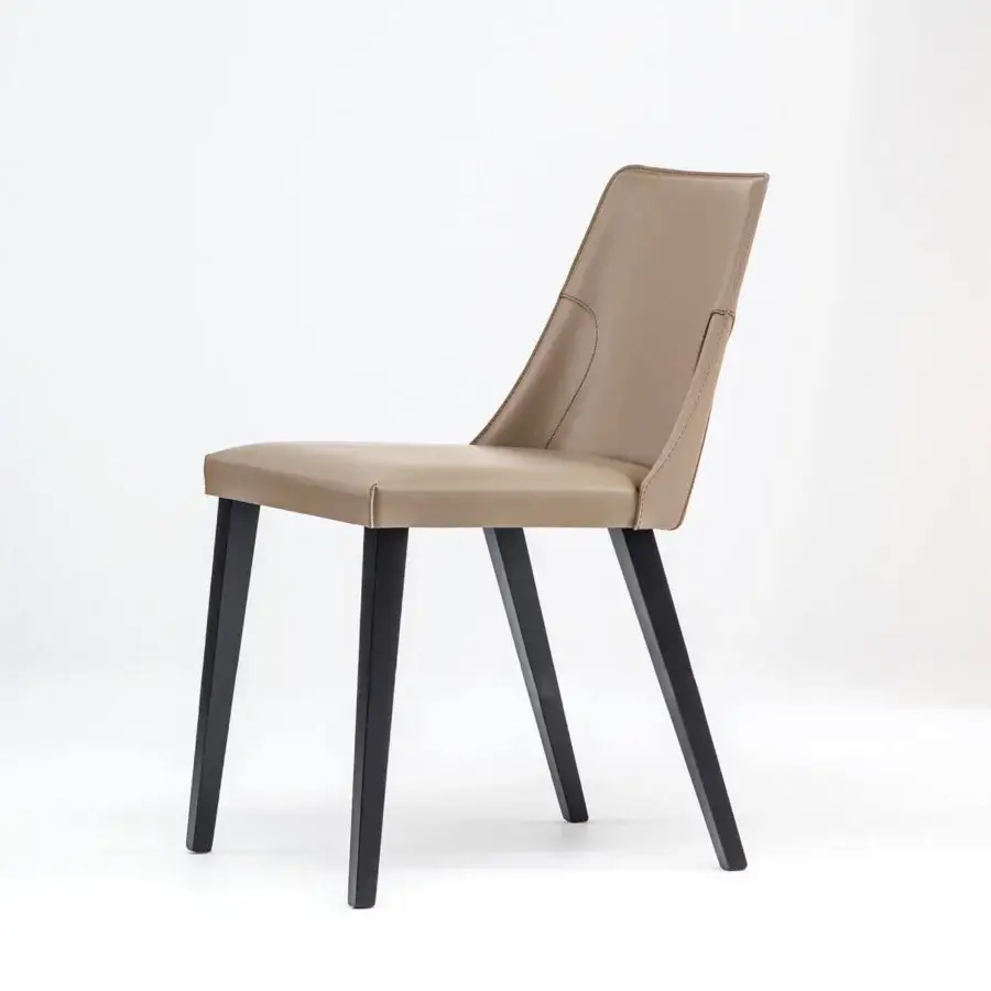 Superior Bross Ned chair upholstered in light tan leather with sleek dark-stained wooden legs crafted in Italy