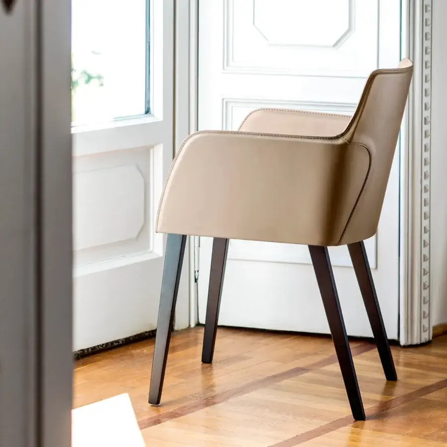 Elegant Bross Ned armchair crafted in premium beige leather with matte finish dark wood legs