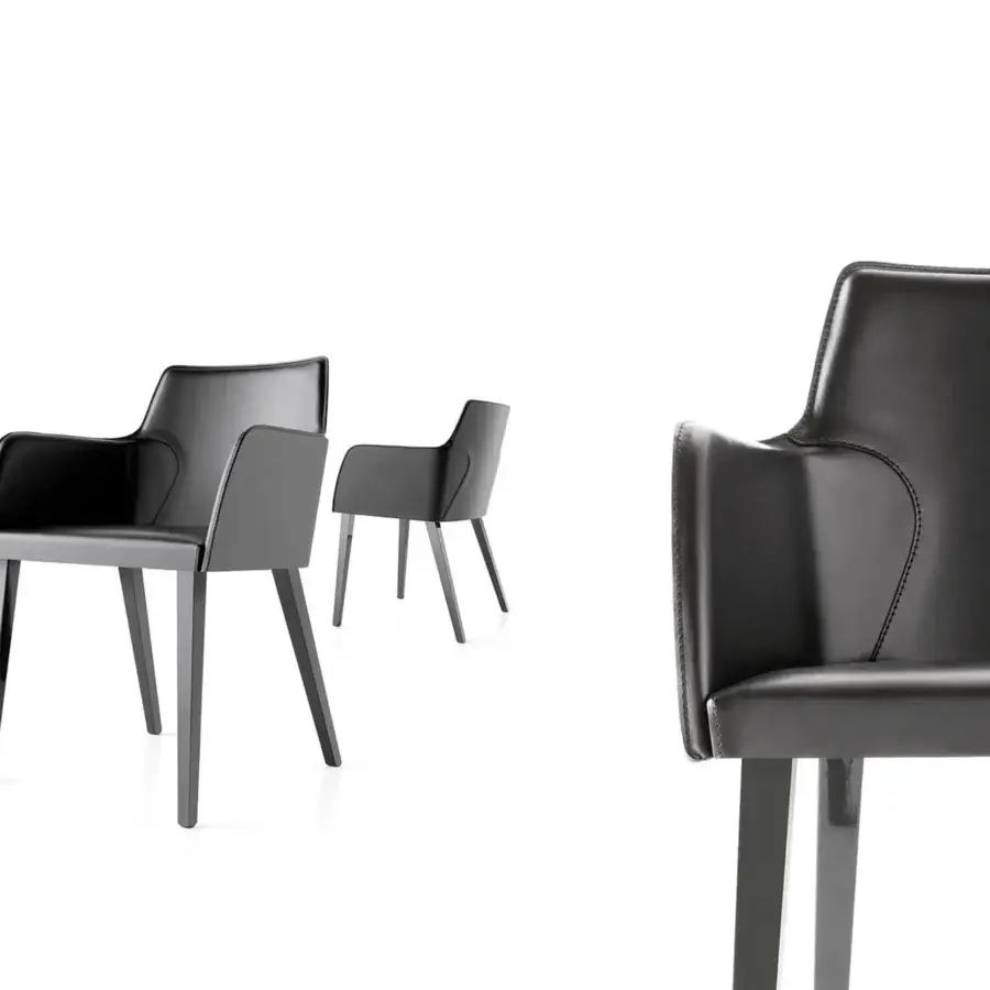 Superior Bross Ned armchair with high wood legs and premium dark gray leather in a matte finish