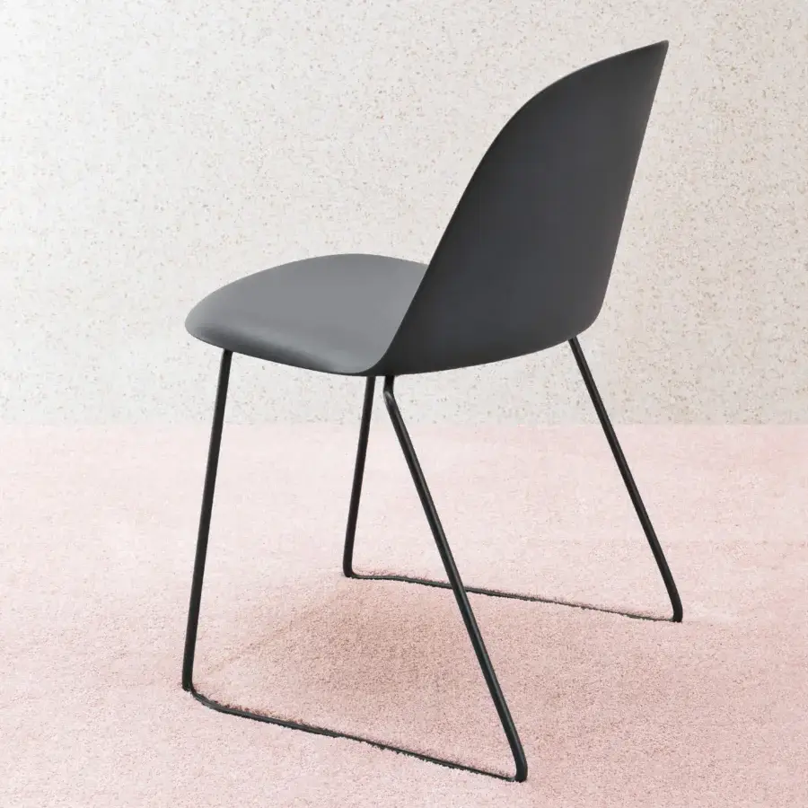 Elegant Miniforms Mariolina sled chair with dark gray molded polypropylene seat and black metal base