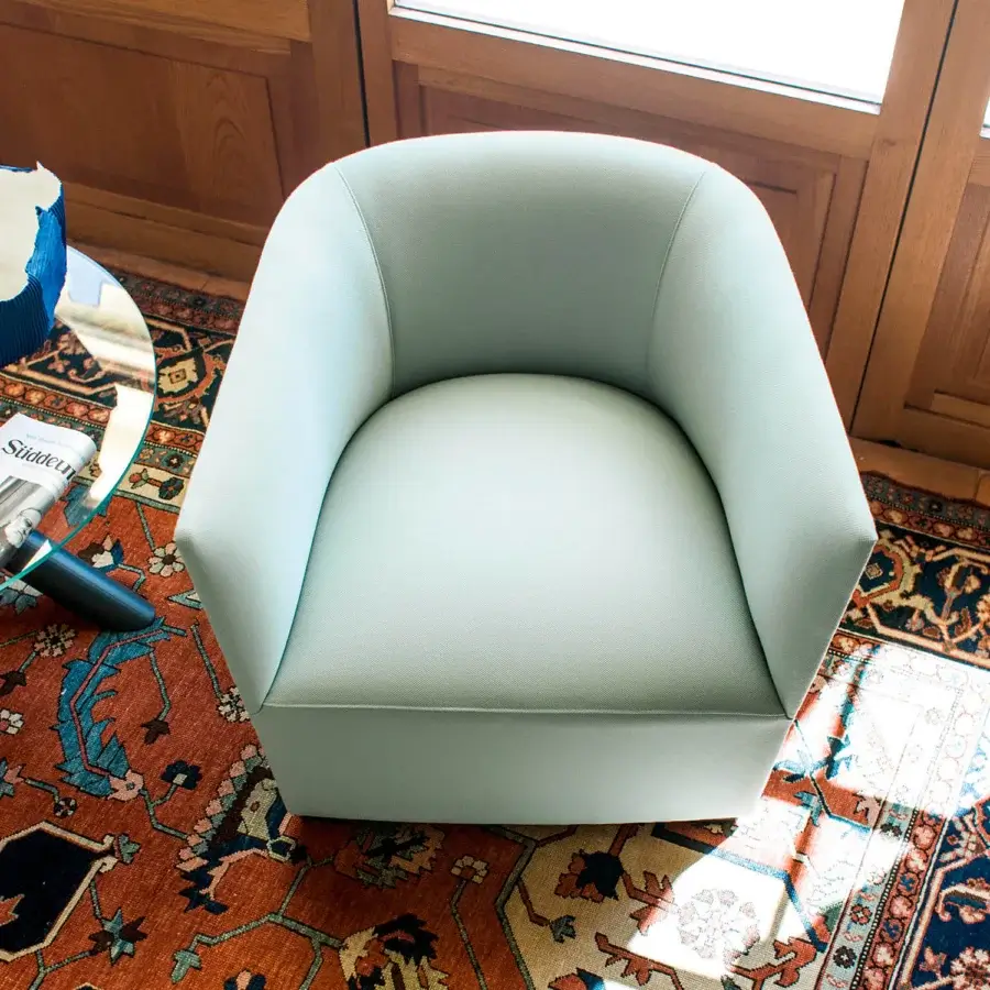 Exceptional Bross Nest lounge chair crafted in Italy with smooth light muted green premium fabric and curved design