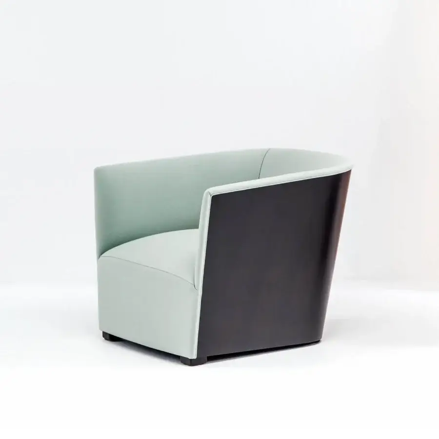 Exceptional Bross Nest lounge chair with pale green fabric and dark-toned wood, exhibiting a curved silhouette