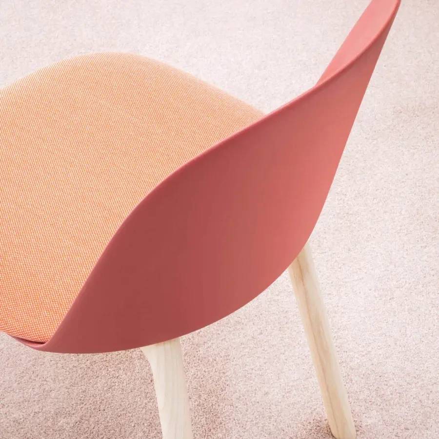 Superior Miniforms Mariolina Wood chair with muted red plastic frame and light orange textile crafted with light-toned wooden legs