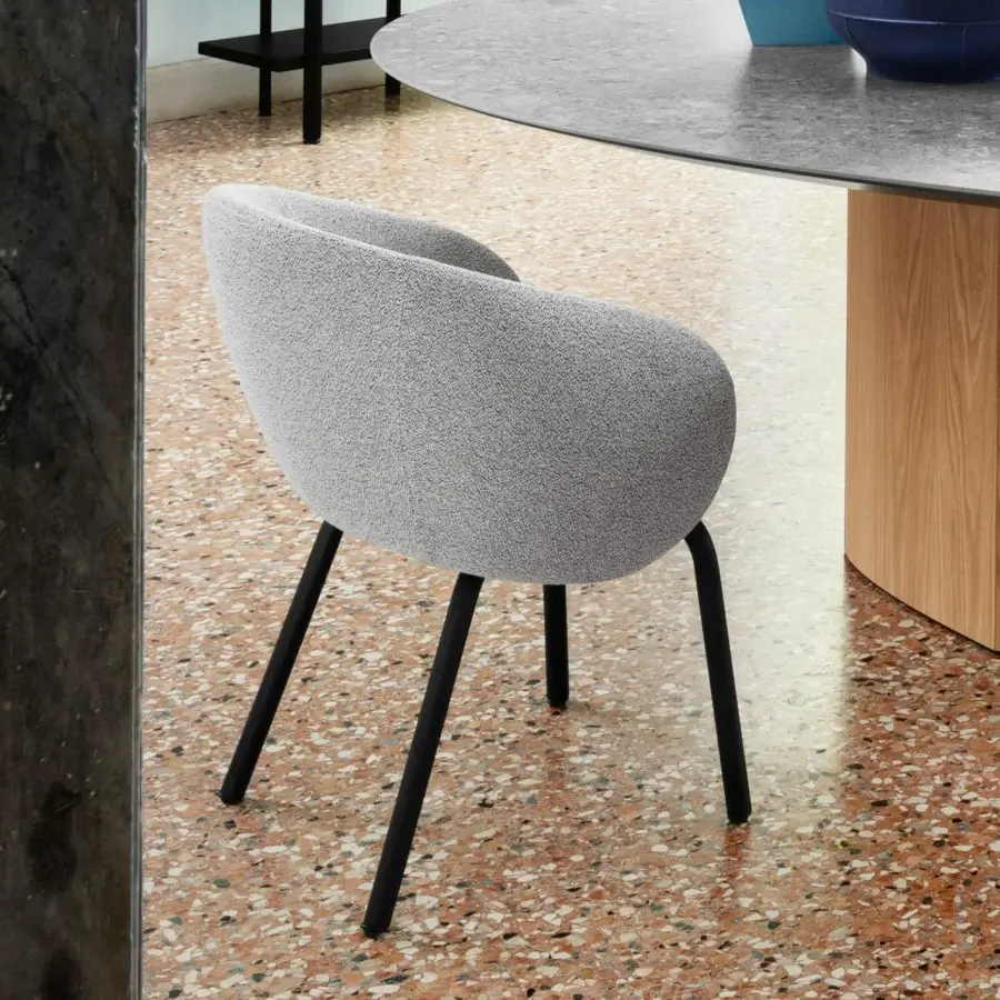 Elegant Miniforms Nebula Tube chair upholstered in textured matte gray with slender black metal legs and recyclable polyurethane shell