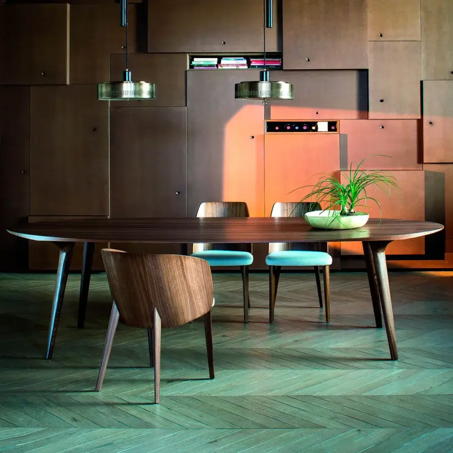 Elegant Bross Shell table with elongated oval top in wood and dark brown finish crafted with subtly tapered legs