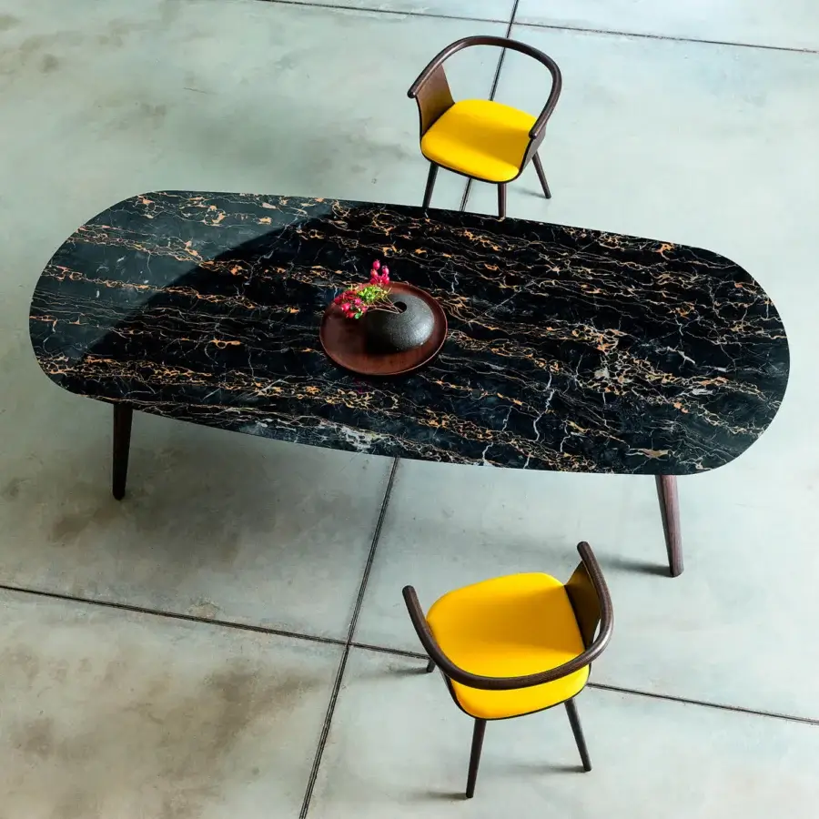 Exceptional Bross Ademar table with dark, marble-like Fenix top exhibiting gold veining and solid oak legs