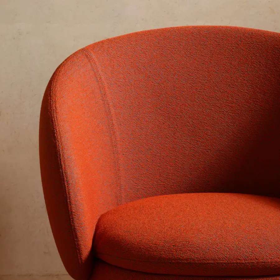 Distinguished Miniforms Nebula Monaca chair with enveloping design, sleek lines and warm orange textured textile shell