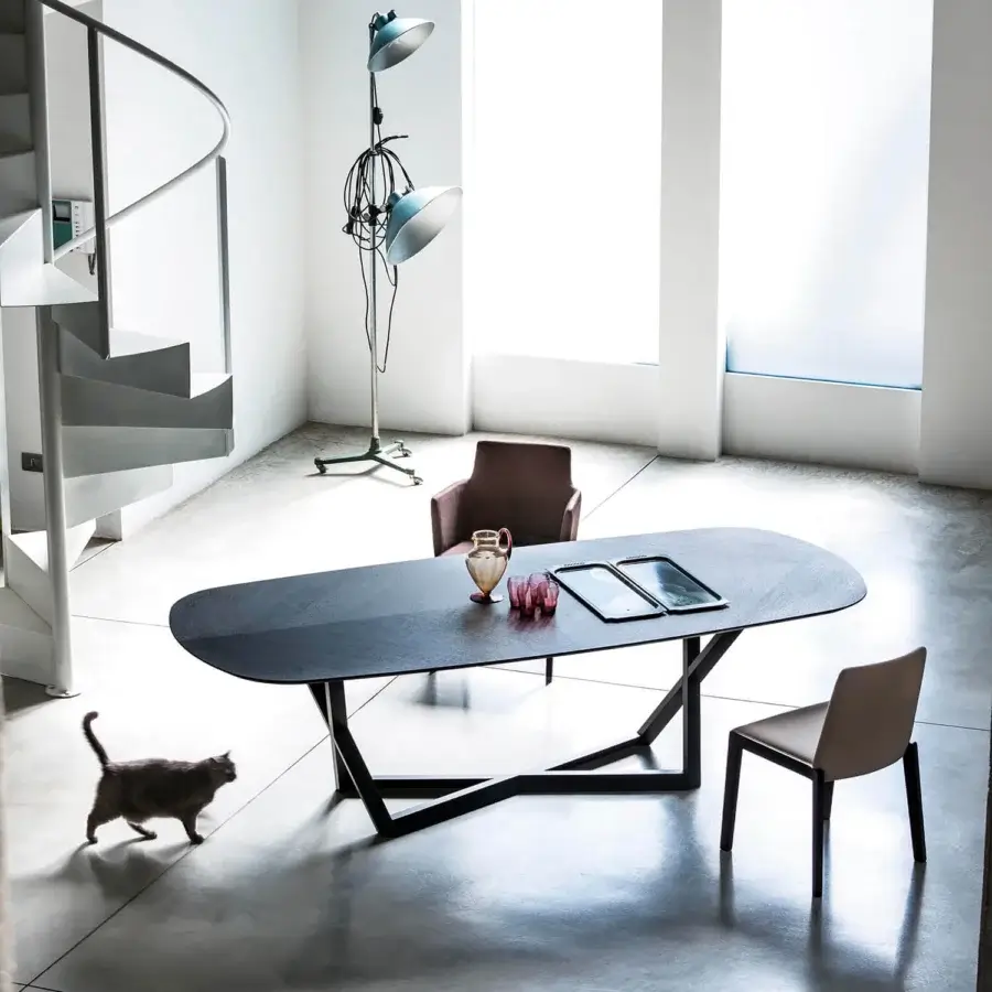 Exceptional Bross Bridget table with solid oak frame and oval dark matte wood tabletop supported by crossing trapezoidal bases