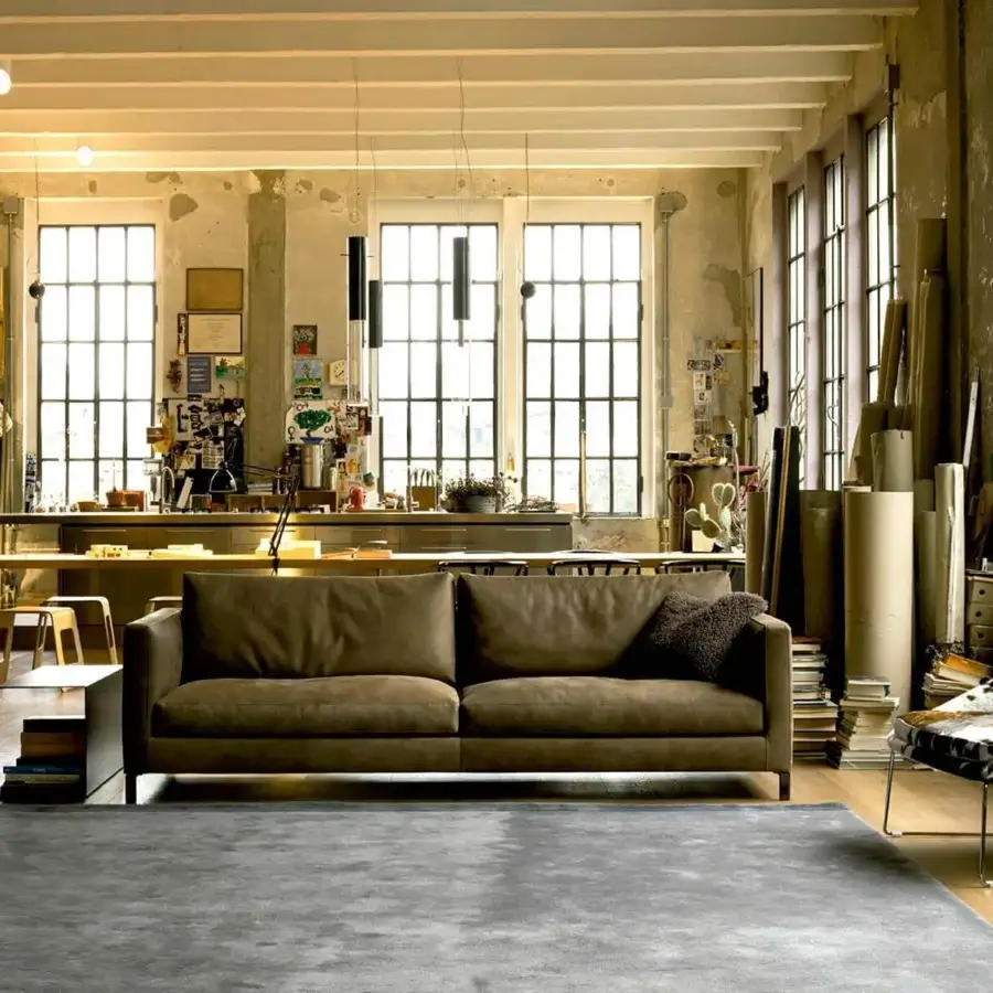 Elegant Verzelloni Hampton sofa with muted brown upholstery and a low dark base crafted in solid wood and plywood