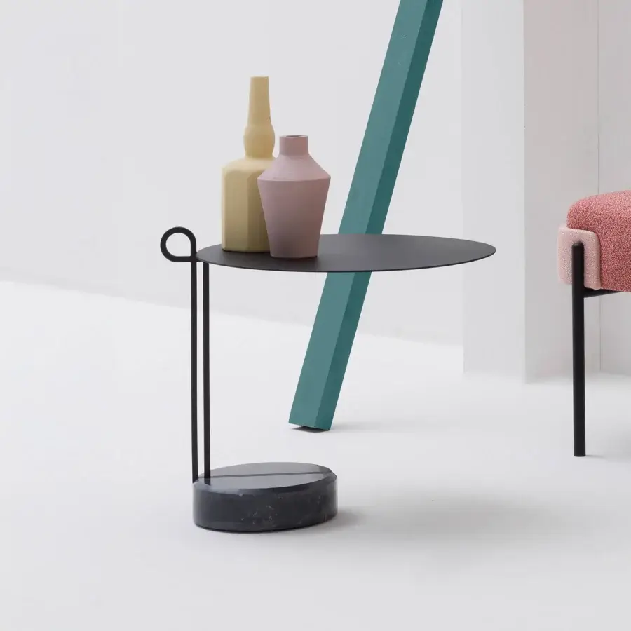 Distinctive Bross Loop coffee table with a looping slender black metal frame and monolithic Black Marquina marble base