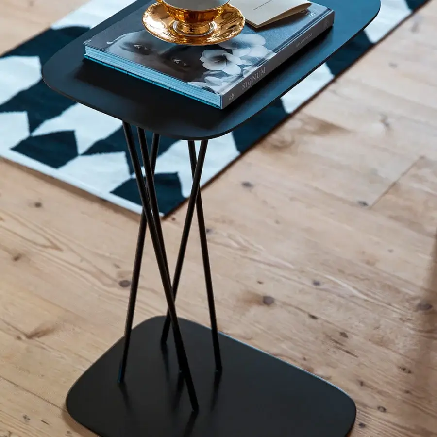 Distinguished Bross Mika side table with a sleek Phoenix black tabletop and slender black lacquered metal rod base crafted in Italy