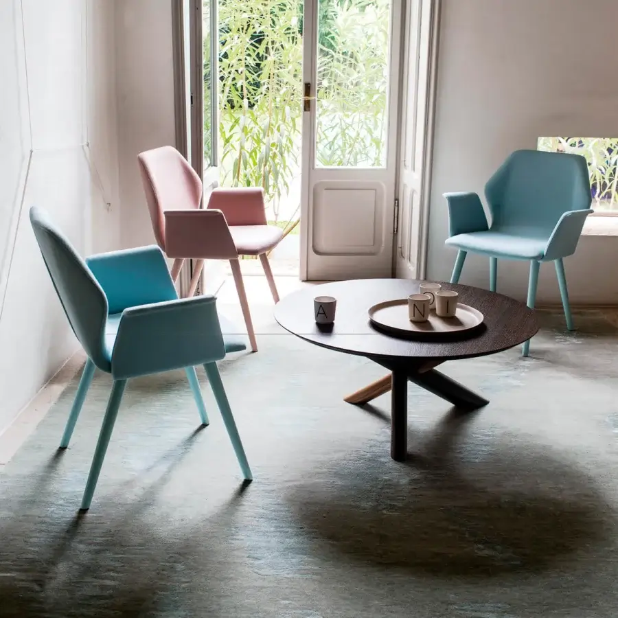 Captivating Bross W table crafted in Italy with a dark finished American walnut base and round wood tabletop