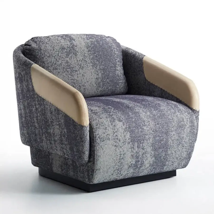 Sophisticated Casamania Worn lounge chair upholstered in textured gray and blue fabric with light tan faux leather accents