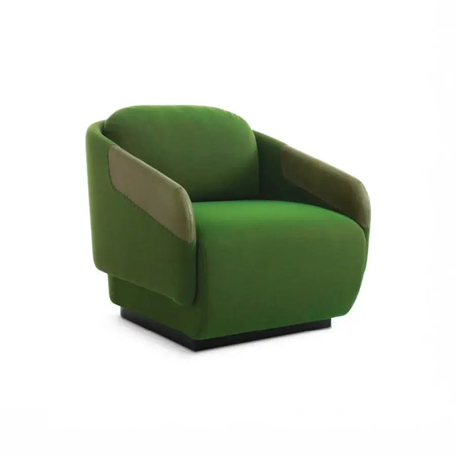 Distinguished Casamania Worn lounge chair upholstered in matte green fabric with tan faux leather armrests and decorative stitching