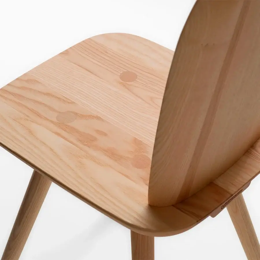 Elegant Casamania La Dina chair crafted from light natural-toned wood with a smooth finish and visible wood grain