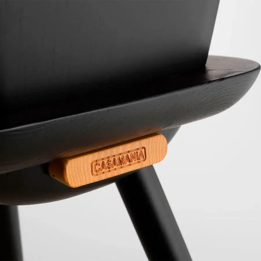 Superior Casamania La Dina chair in black with light brown wood detail displaying the brand name and matte finish