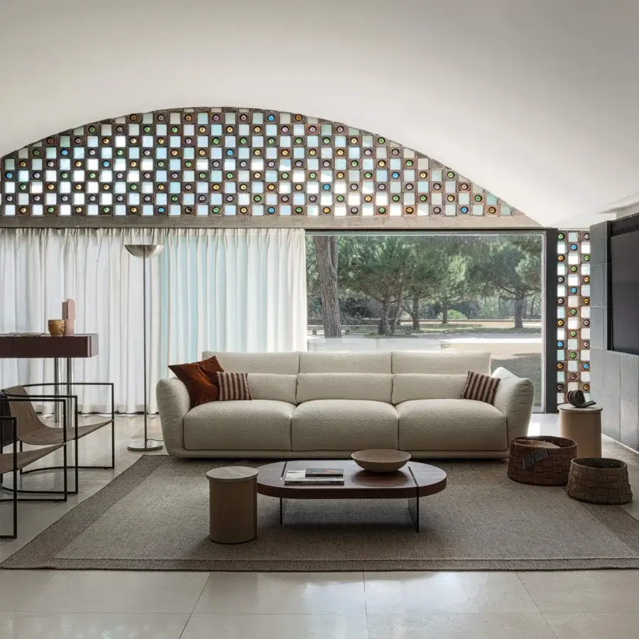 Distinguished Cierre1972 Clift sofa with textured cream textile upholstery and striped brown cushions